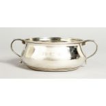 A MAPPIN & WEBB CIRCULAR SILVER TWO-HANDLED BOWL. 3.5ins diameter. Birmingham 1938.