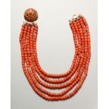 A SUPERB FIVE-ROW OF CORAL BEADS with gold clasp.