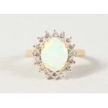 AN 18CT YELLOW GOLD, OPAL AND DIAMOND CLUSTER RING.