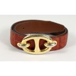 A BROWN LEATHER AND GILT BELT. 36ins long.
