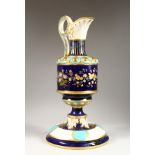 A CONTINENTAL PORCELAIN EWER, dark blue ground with floral and gilt decoration, on a matching stand.