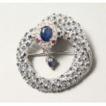 A SILVER SAPPHIRE SET PANTHER SNAKE BROOCH.