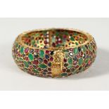 A SUPERB 18CT GOLD, EMERALD, RUBY AND SAPPHIRE BANGLE. 54gms.