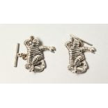 A PAIR OF MICHELIN MEN SILVER CUFFLINKS.