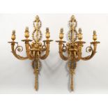 A PAR OF CAST METAL THREE LIGHT CLASSICAL STYLE WALL APPLIQUES. 27.5ins high.