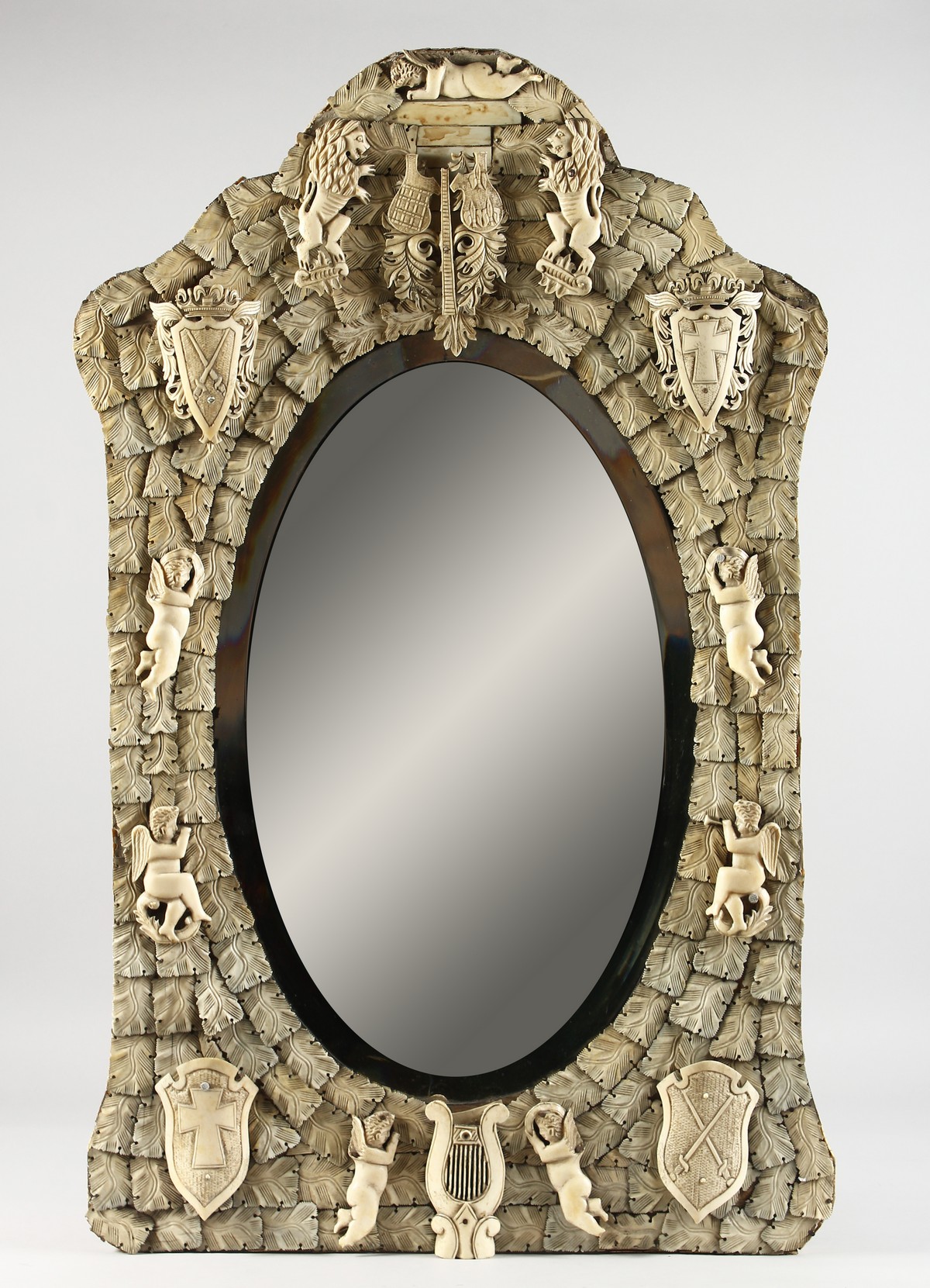 A GOOD DIEPPE PRISONER OF WAR CARVED BONE MIRROR, CIRCA. 1860, with emblems, shields, etc., with