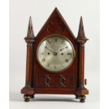 A 19TH CENTURY MAHOGANY MANTLE CLOCK, with eight day movement, the circular silvered dial signed