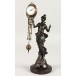 AN ART NOUVEAU STYLE MYSTERY CLOCK OF A STANDING LADY on a circular base. 11ins high.