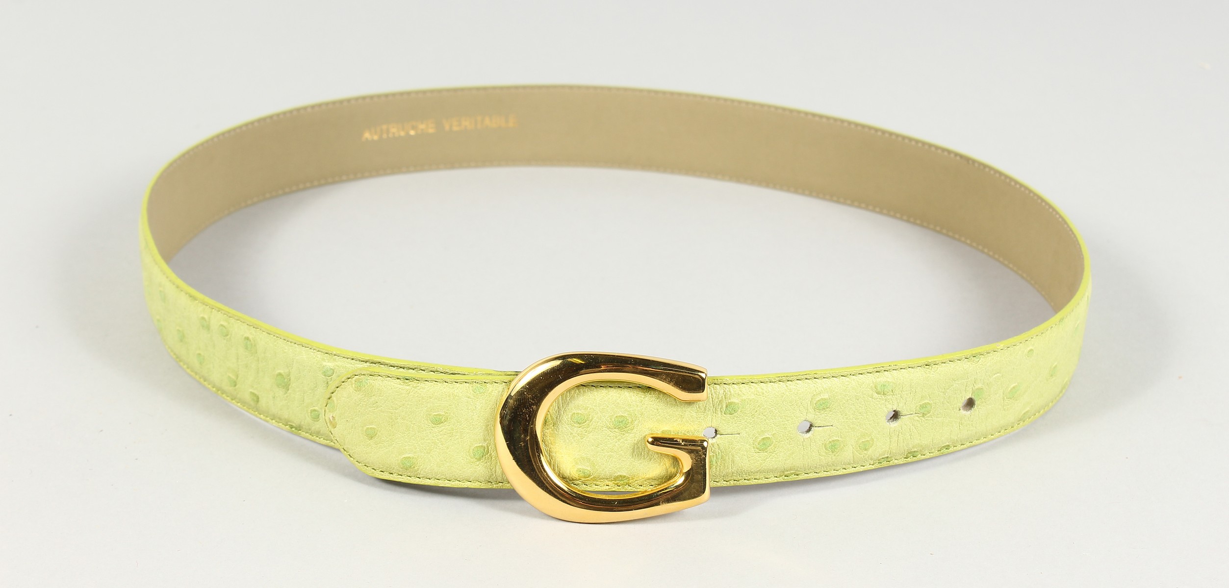 A GREEN LEATHER AND GILT BELT. 26ins long.