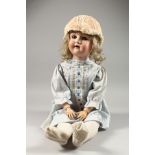 A LATE 19TH CENTURY/EARLY 20TH CENTURY PORCELAIN HEADED DOLL. 28ins high.