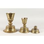 THREE COPPER CANDLESTICKS, POSSIBLY TURKISH. 9ins, 6.5ins and 5.5ins high.