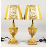 A PAIR OF YELLOW TOLEWARE LAMPS AND SHADES.