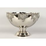 A LARGE SILVER PLATE CIRCULAR PUNCH BOWL with fruiting vines, on a circular base. 15ins diameter.