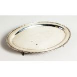 AN OVAL SILVER BEAD EDGE TEAPOT STAND. 7ins wide. Birmingham 1946.