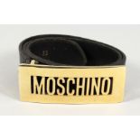 A MOSCHINO ITALIAN BLACK LEATHER AND GILT NAME BELT. 32ins long.