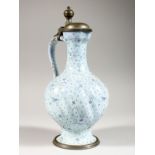 A CONTINENTAL TIN-GLAZED JUG, with hinged pewter cover and base. 10.5ins high.