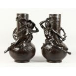 A SUPERB LARGE PAIR OF BRONZE BULBOUS VASES with two reclining nudes and male figures as handles.