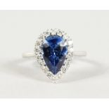 A SUPERB 18CT WHITE GOLD, PEAR SHAPED SAPPHIRE (4CTS) AND DIAMOND RING.