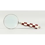 A MAGNIFYING GLASS WITH CHEQUERED HANDLE.