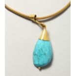 AN ISLAMIC TURQUOISE PENDANT on a chain.