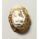 A SMALL GILT METAL MOUNTED CAMEO BROOCH. 1in high.