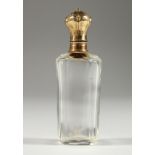 A GLASS GOLD TOP SCENT BOTTLE AND STOPPER. 9.5cms long.