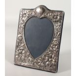 A HEART SHAPED PHOTOGRAPH FRAME with flowers. 7.25ins x 5ins.