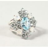 A SILVER, BLUE TOPAZ AND MOONSTONE RING.