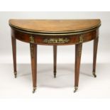 A FRENCH EMPIRE MAHOGANY DEMILUNE FOLD-OVER CARD TABLE, with ormolu mounts, on tapering square