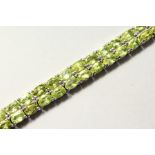 A SILVER DOUBLE ROW PERIDOT LINE BRACELET.