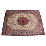 A GOOD PERSIAN CARPET, cream ground with central floral decorated crimson ground panel, the main