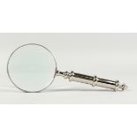 A MAGNIFYING GLASS WITH CHROME HANDLE.