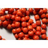 A LONG STRING OF CORAL BEADS.