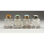 FOUR CUT GLASS, SILVER AND ENAMEL TOP SALTS.