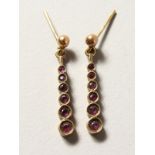 A PAIR OF 9CT GOLD RUBY EARRINGS.