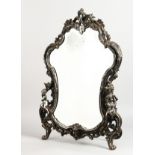 A GOOD, LARGE, SILVER PLATED EASEL MIRROR, rococo style, mounted with cherubs. 24ins high x 17ins