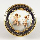 A CONTINENTAL RICH BLUE PORCELAIN CIRCULAR BOX AND COVER, the lid with cupids. 3ins diameter.