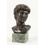 A BRONZE BUST OF A CENTURION on a marble base. 5ins high.