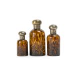 Three graduated tortoise glass bottles