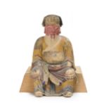 A Chinese polychrome stucco figure of an official on stand