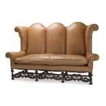 A leather high wing-backed sofa