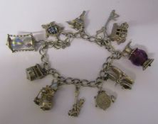 Silver charm bracelet with assorted silver and white metal charms L 7" total weight 1.60 ozt