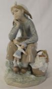 Lladro girl with picnic basket holding doll, height 23cm