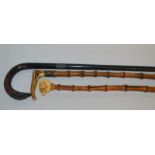 3 walking canes: ivory handle clenched fist pommel (slight damage), antler handle & an ebonized &