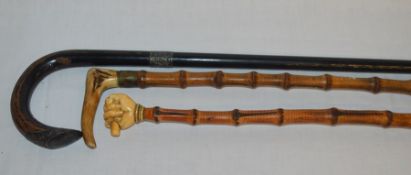 3 walking canes: ivory handle clenched fist pommel (slight damage), antler handle & an ebonized &