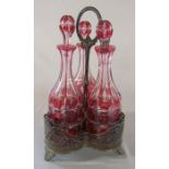 3 cranberry glass decanters in silver plated stand (1 decanter af) H 38 cm