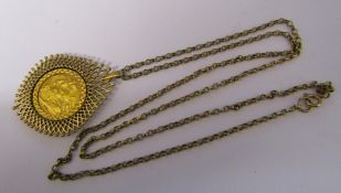 9ct gold chain with George V half sovereign dated 1903 in 9ct gold mount total weight 15.4 g