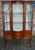 Late Victorian bow fronted display cabinet on tapering legs with inlay stringing & motif Ht 179cm