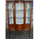 Late Victorian bow fronted display cabinet on tapering legs with inlay stringing & motif Ht 179cm