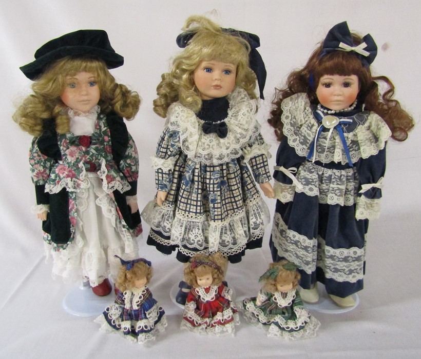 3 collectors dolls on stands with 3 miniature dolls